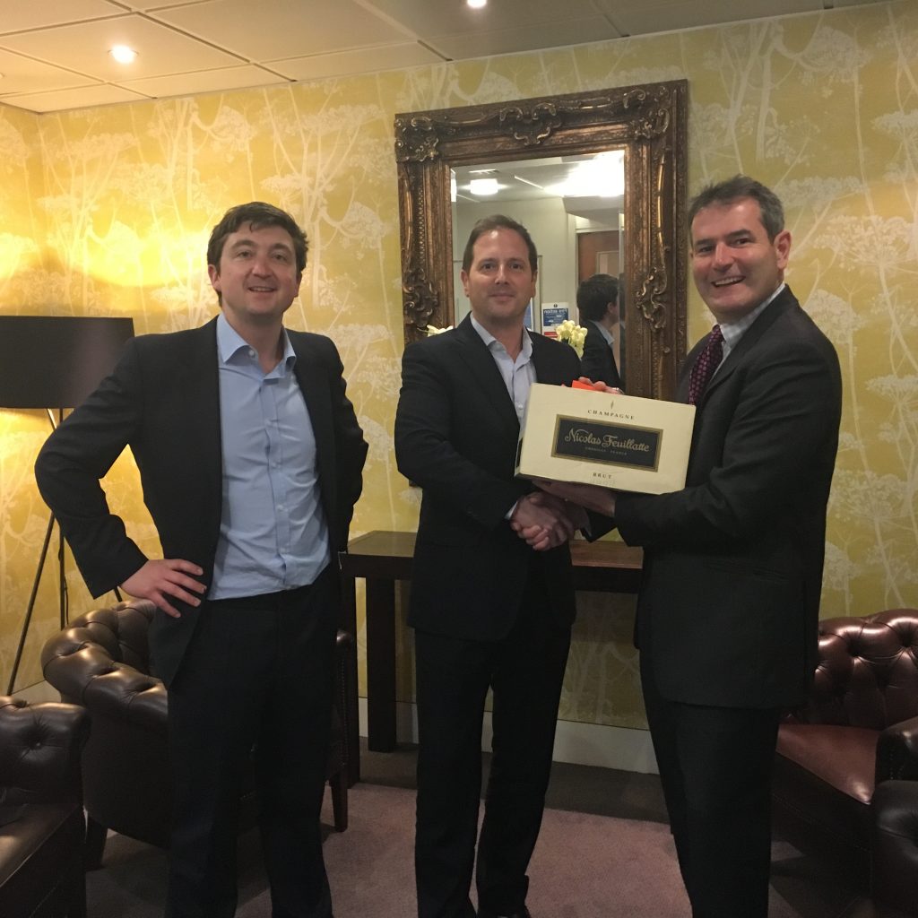 Christopher Stiegeler (centre) receives his case of champagne from Saul Shanagher (r) and Andy Prior (l)